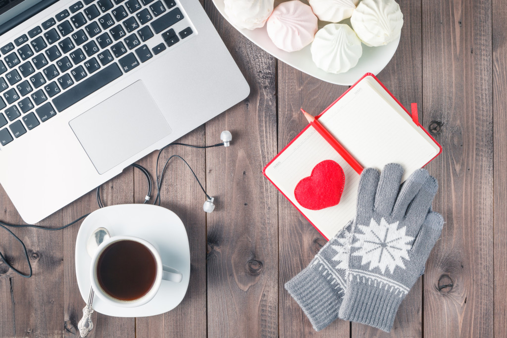 Desk with Red Heart, noteboot and sweets. Valentines Day concept