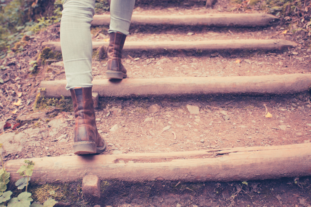 Close up on a young woman's legs as she is walking in nature